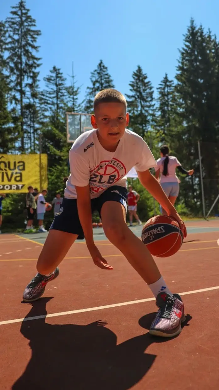 Aleksa Radojević handling the ball during a basketball game.